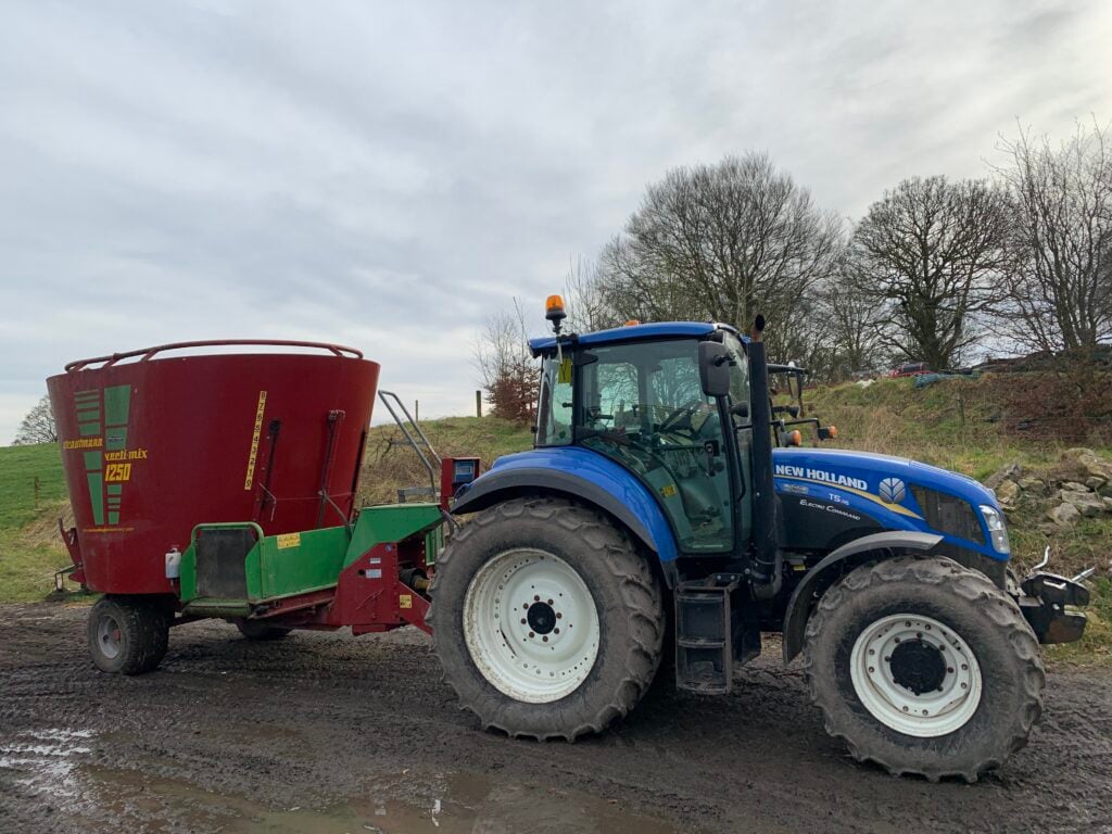 A tractor and diet feeder is used to feed livestock on the farm