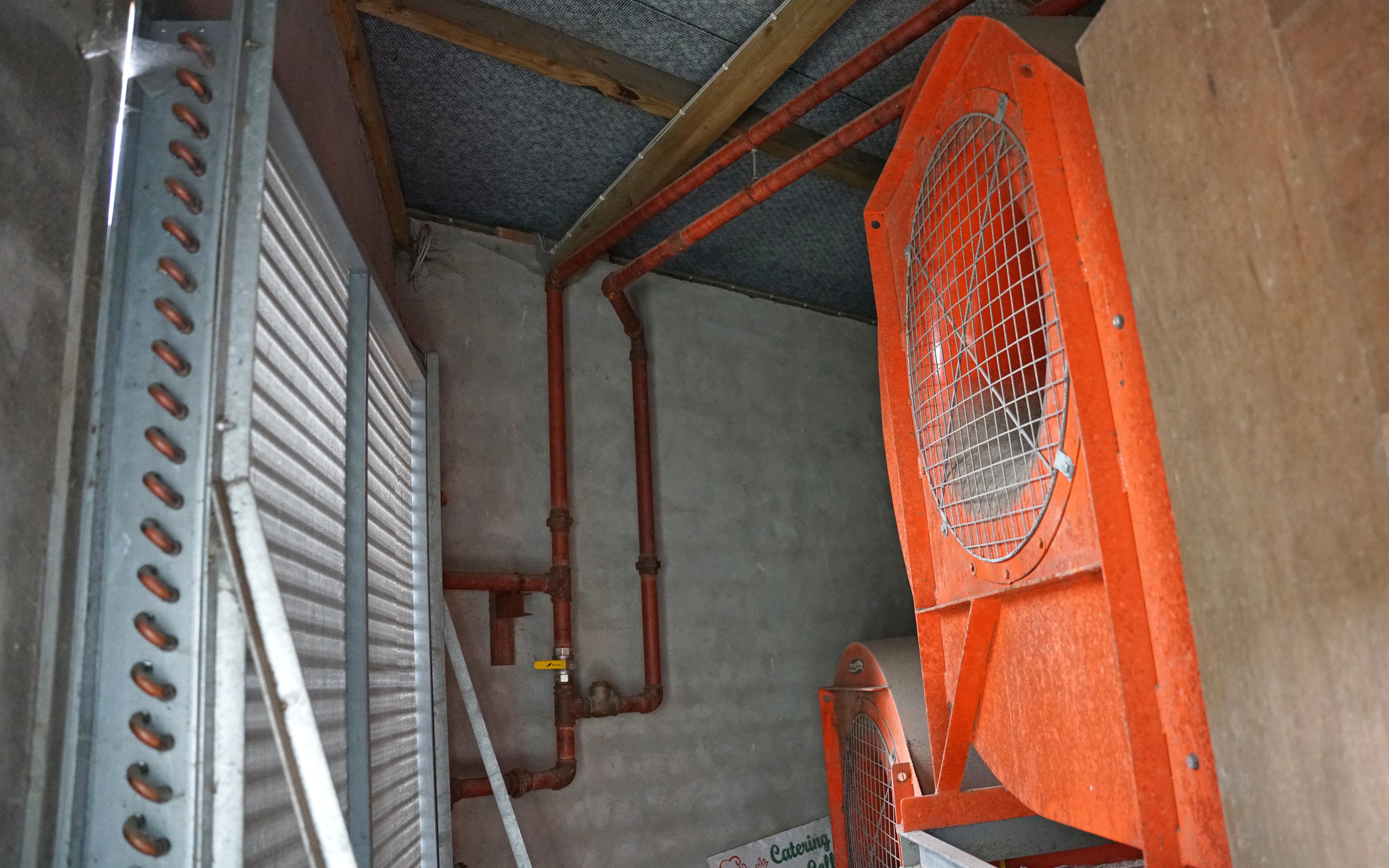 Hot water is piped to the heat exchanger on the left, as air is drawn through it by the fans on the right