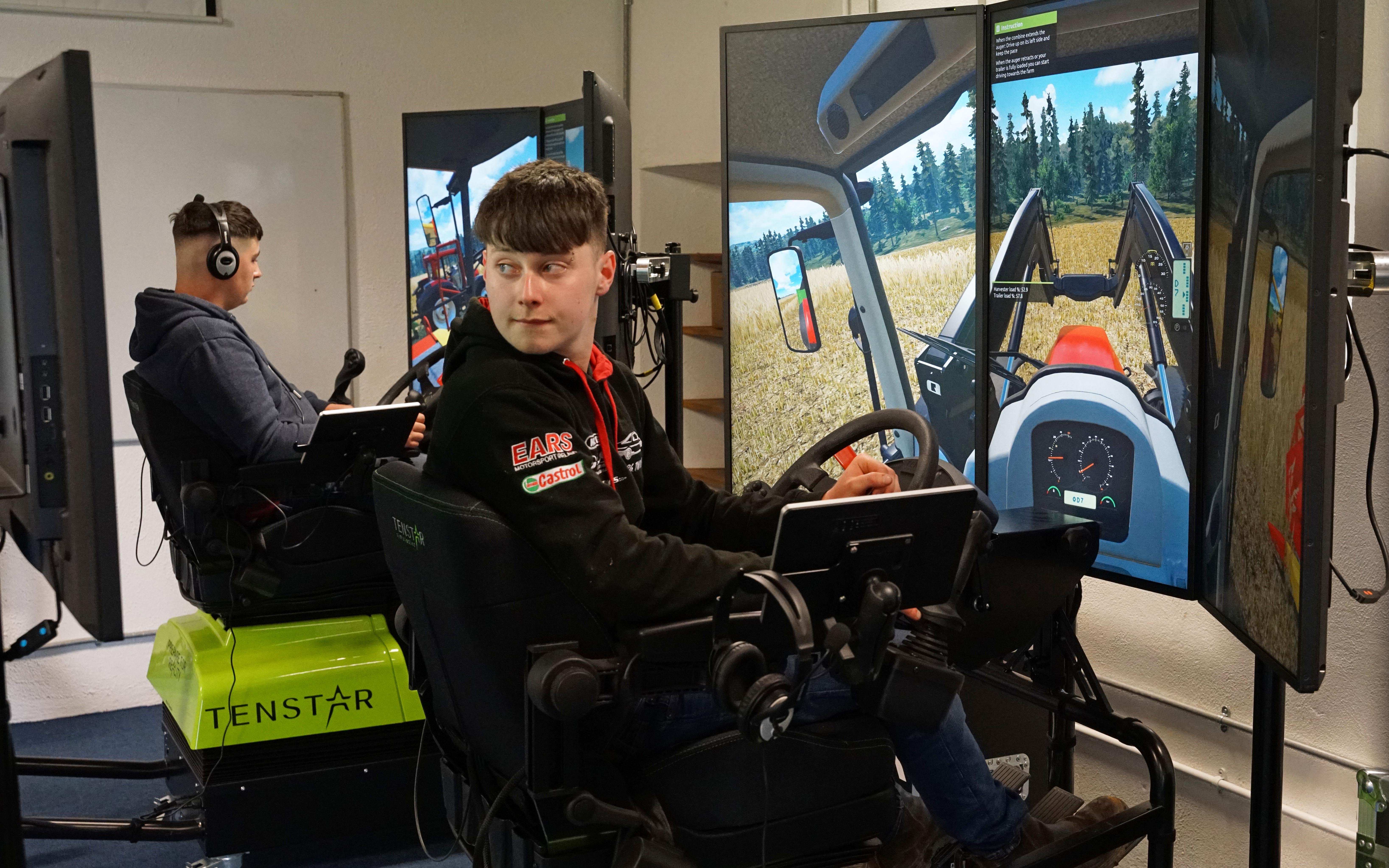 Linking the simulators allows Colm Pierce (left) and Piaras Murphy to practice unloading a combine on the go