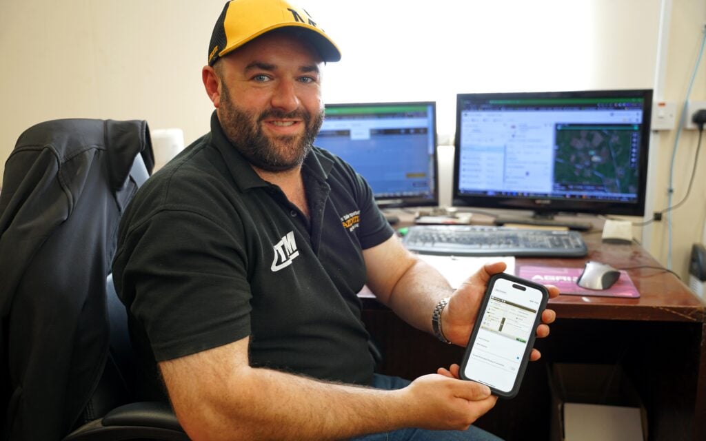 Niall Flynn with the John Deere mobile app, by which, he can access the data and troubleshoot machinery issues