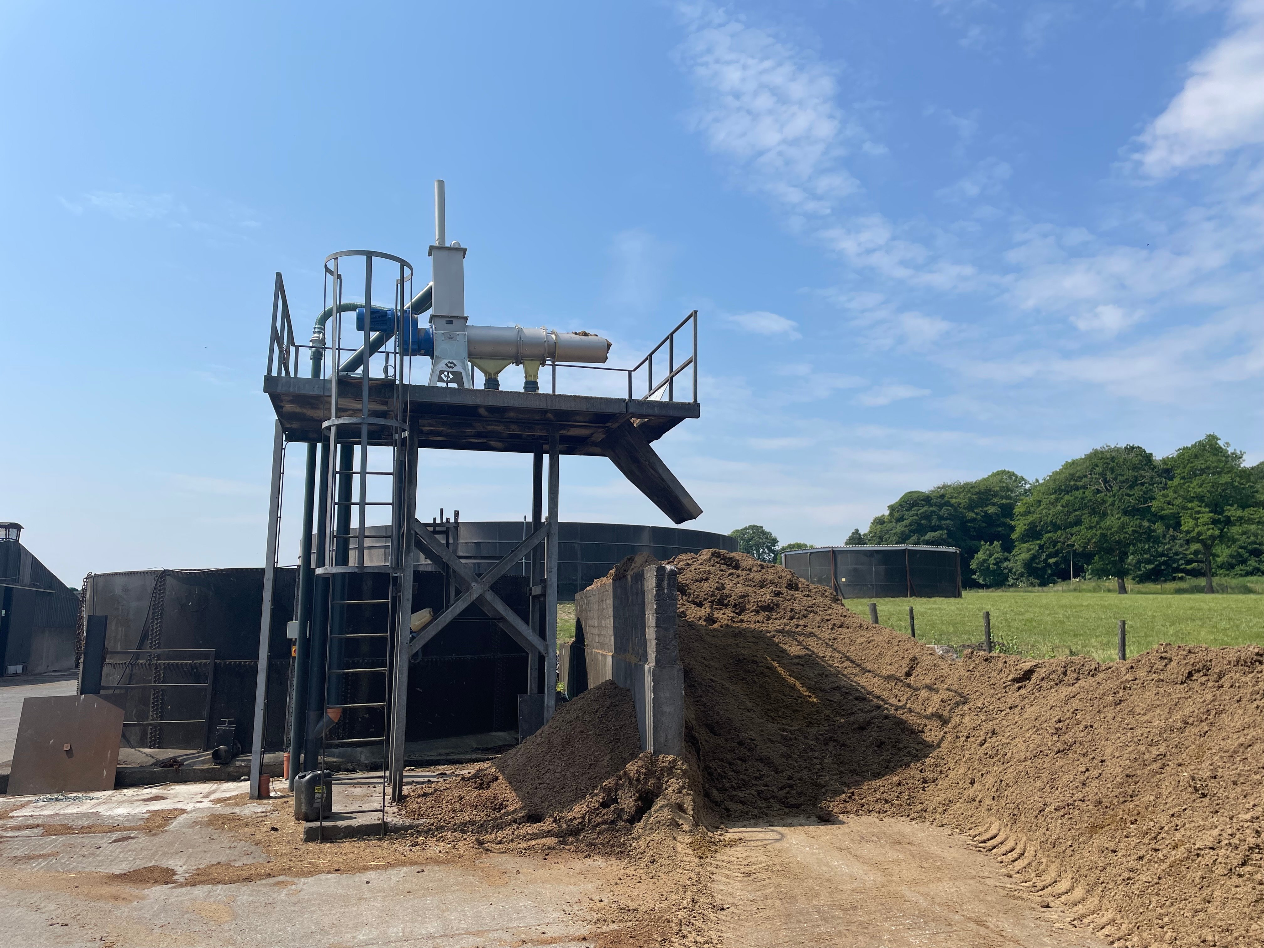 An electric motor pumps slurry to the separator (top) where the solids are extracted and the liquid is stored in the tank to the rear of the apparatus. The pile on the right is the dried manure which is very similar to compost