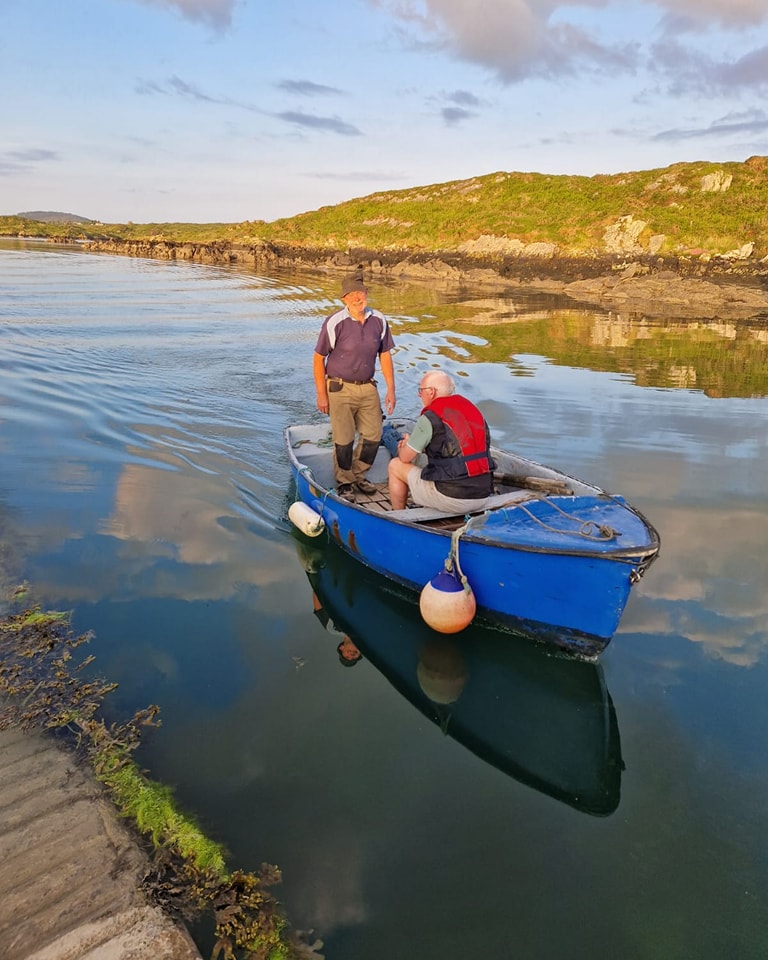 AI technician Connie, seated, and Sherkin islander Michael departing to the island. Image: Fiona Collins