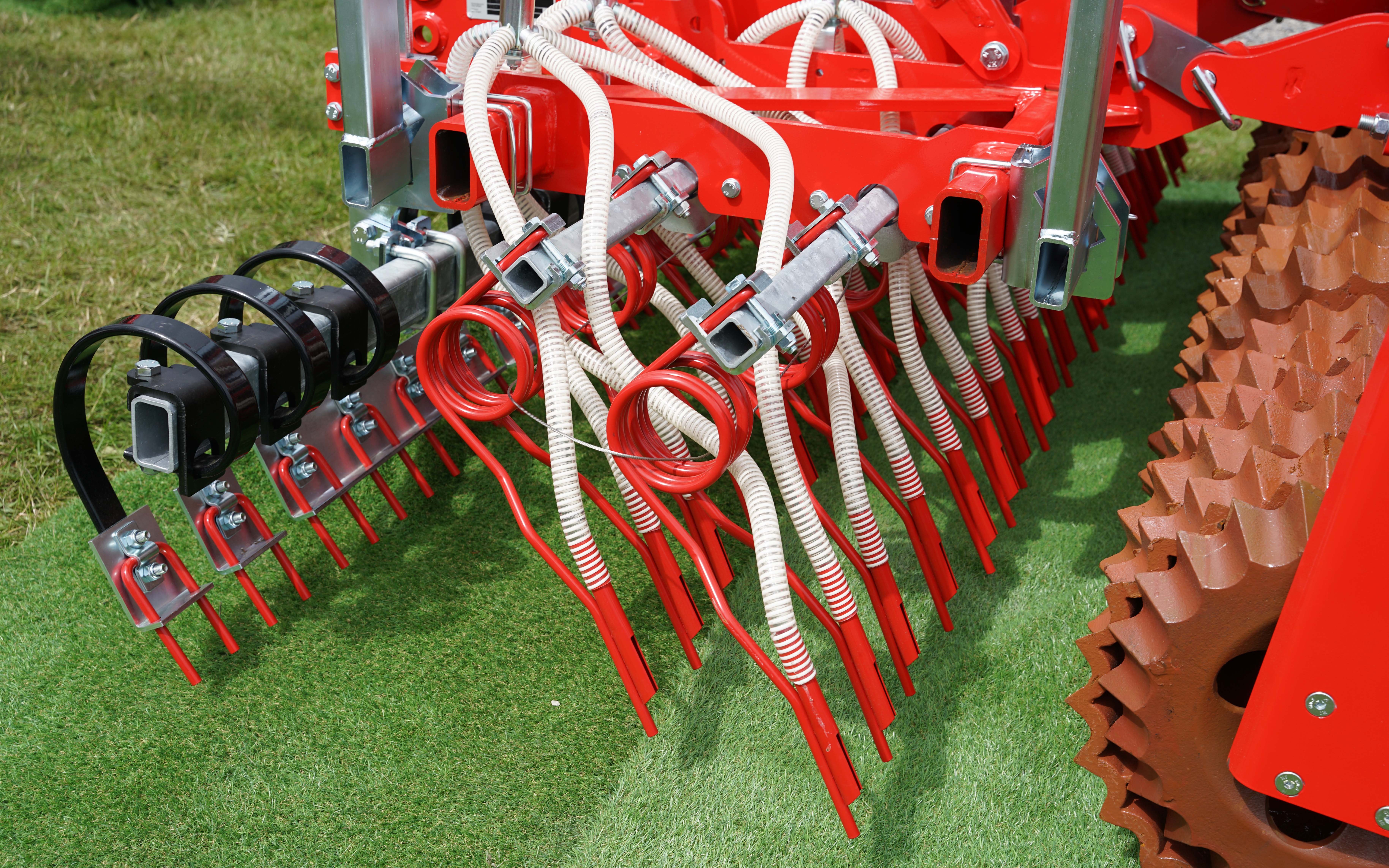 Seeds are now passed down the back of the tine into the soil mix rather than broadcast by air in front of the roller.