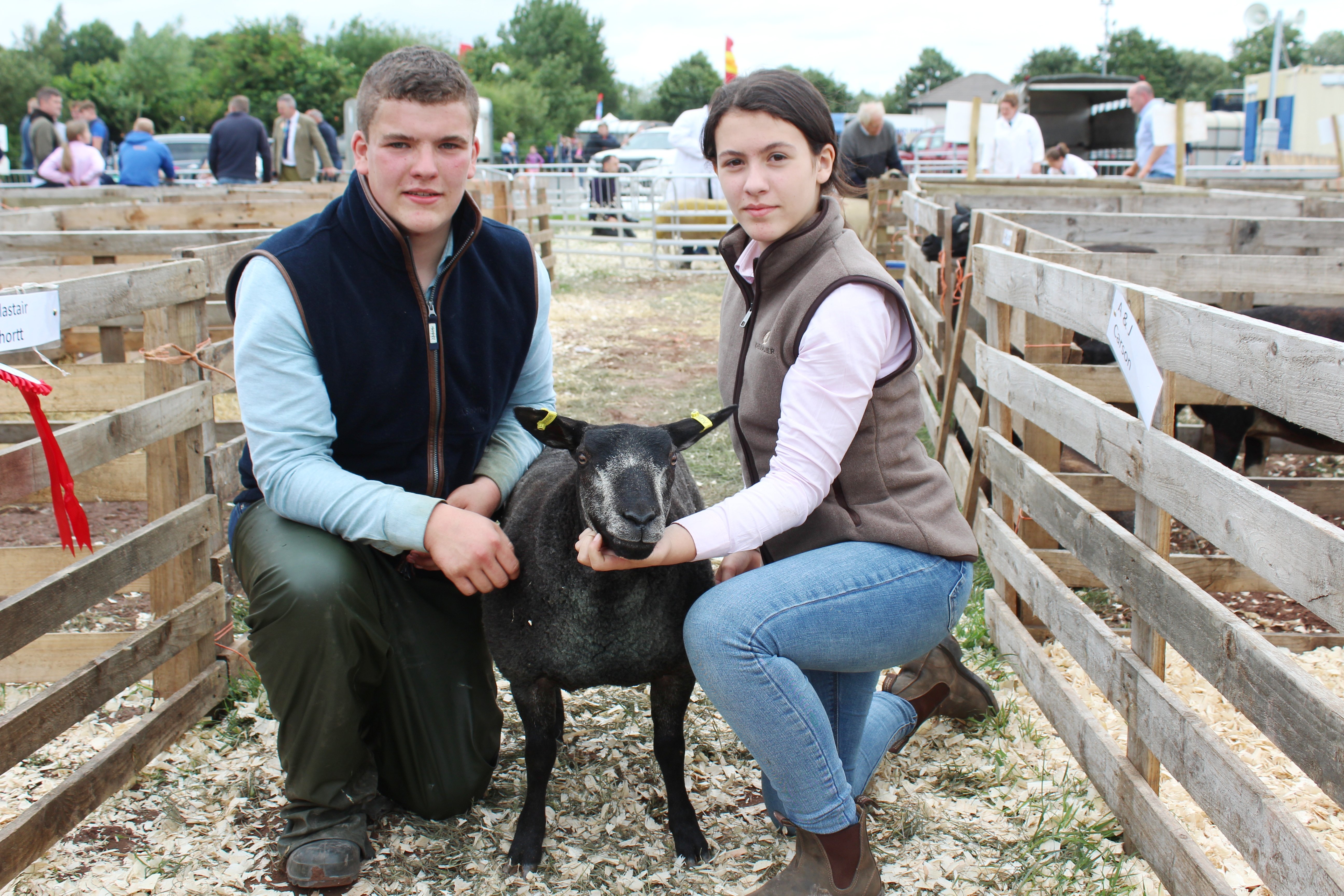 Bailey and Shannon Smith, from Castlederg in Co Tyrone, with a Blue Faced Texel ewe lamb at Omagh Show 2023