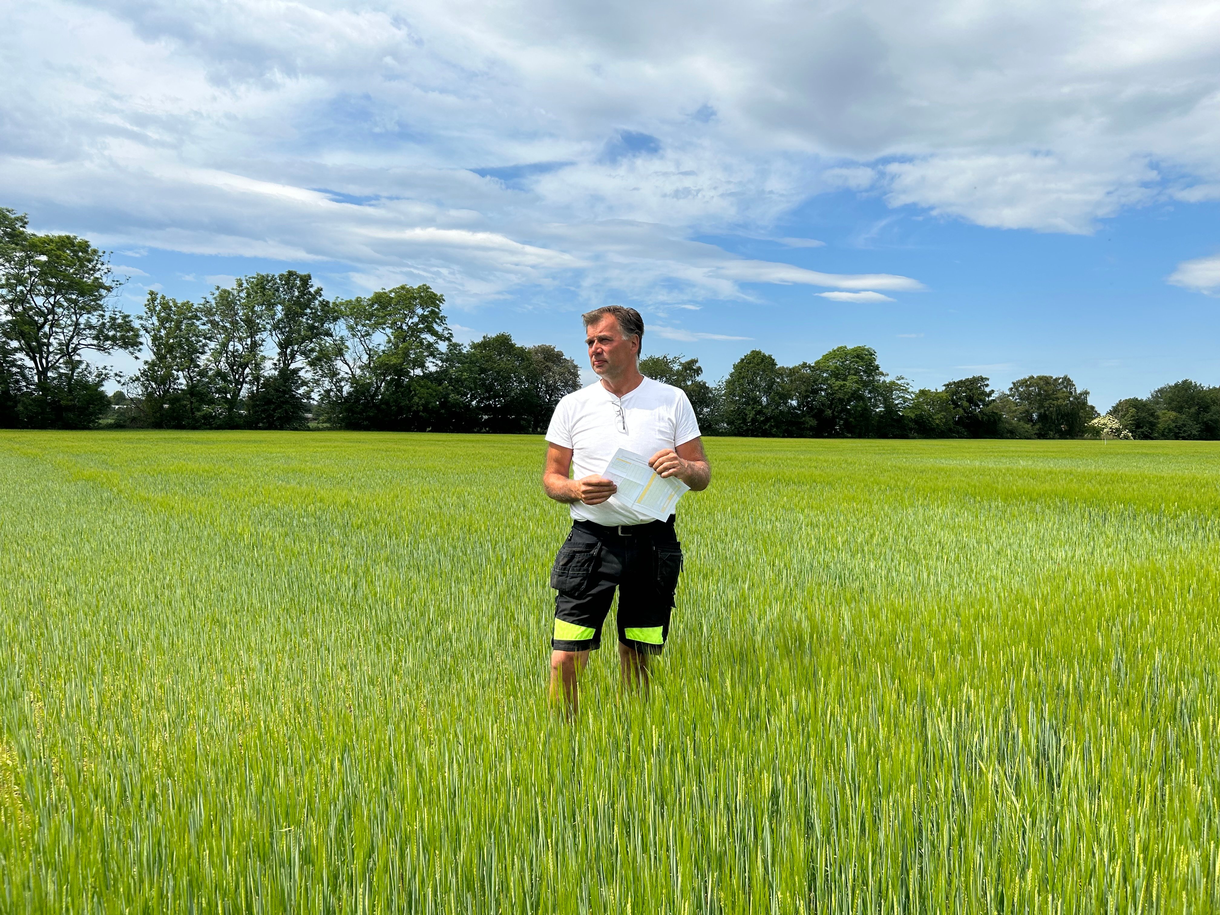 Roland Andersson in a barley field at his farm in Skåne