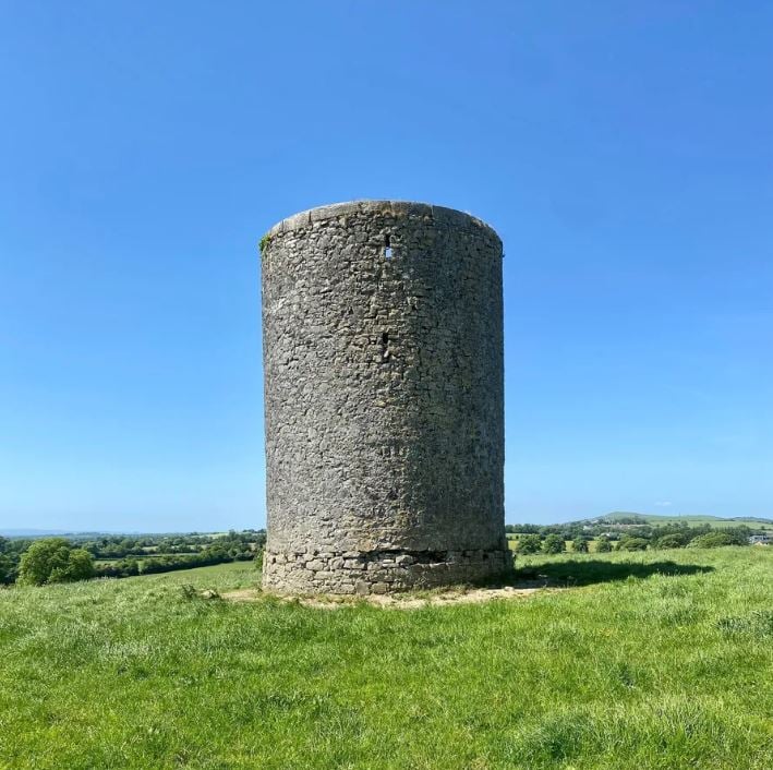 The property includes an old windmill tower