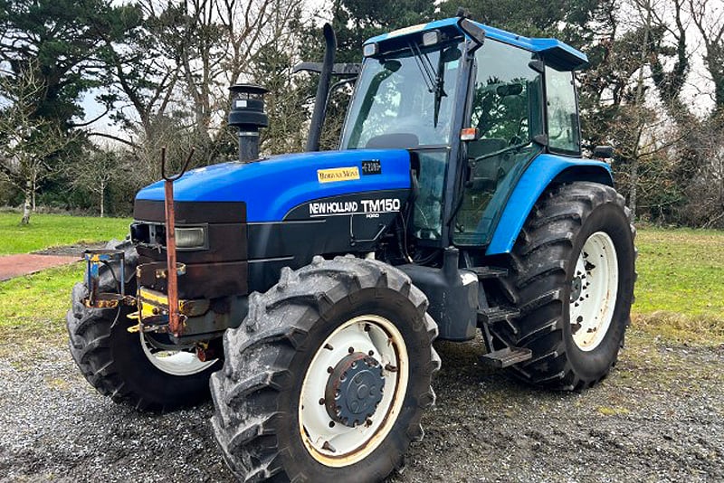 2000 New Holland 4WD TM150 Tractor with 150hp on tap. It's showing  7081 Hours On Clock, has 8 Spool Valves, Hydraulic Lifting Arms, Fine Spline PTO . All cab Glass is intact but there is a missing interior panel .