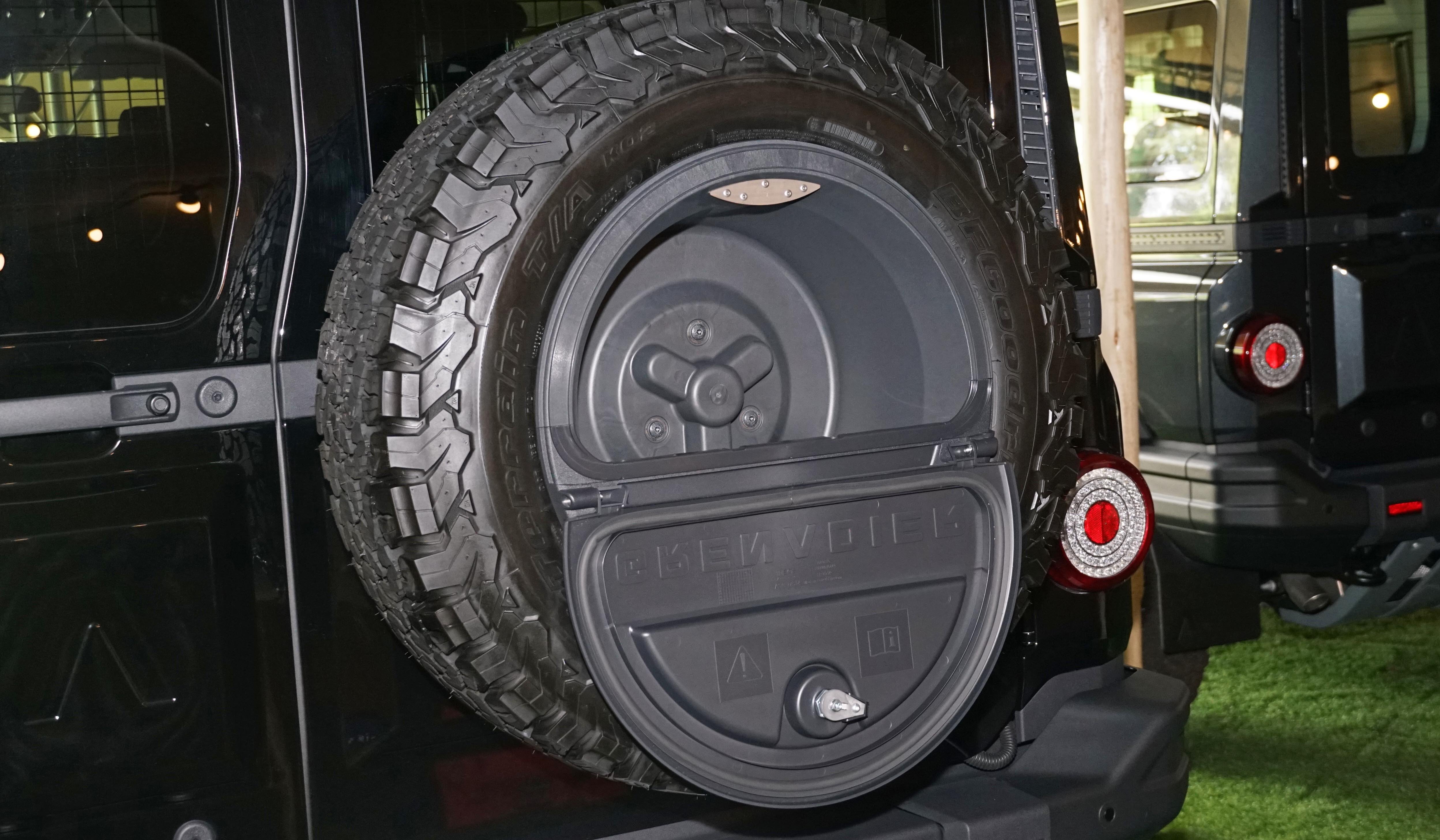 One option is this storage unit in the centre of the spare wheel