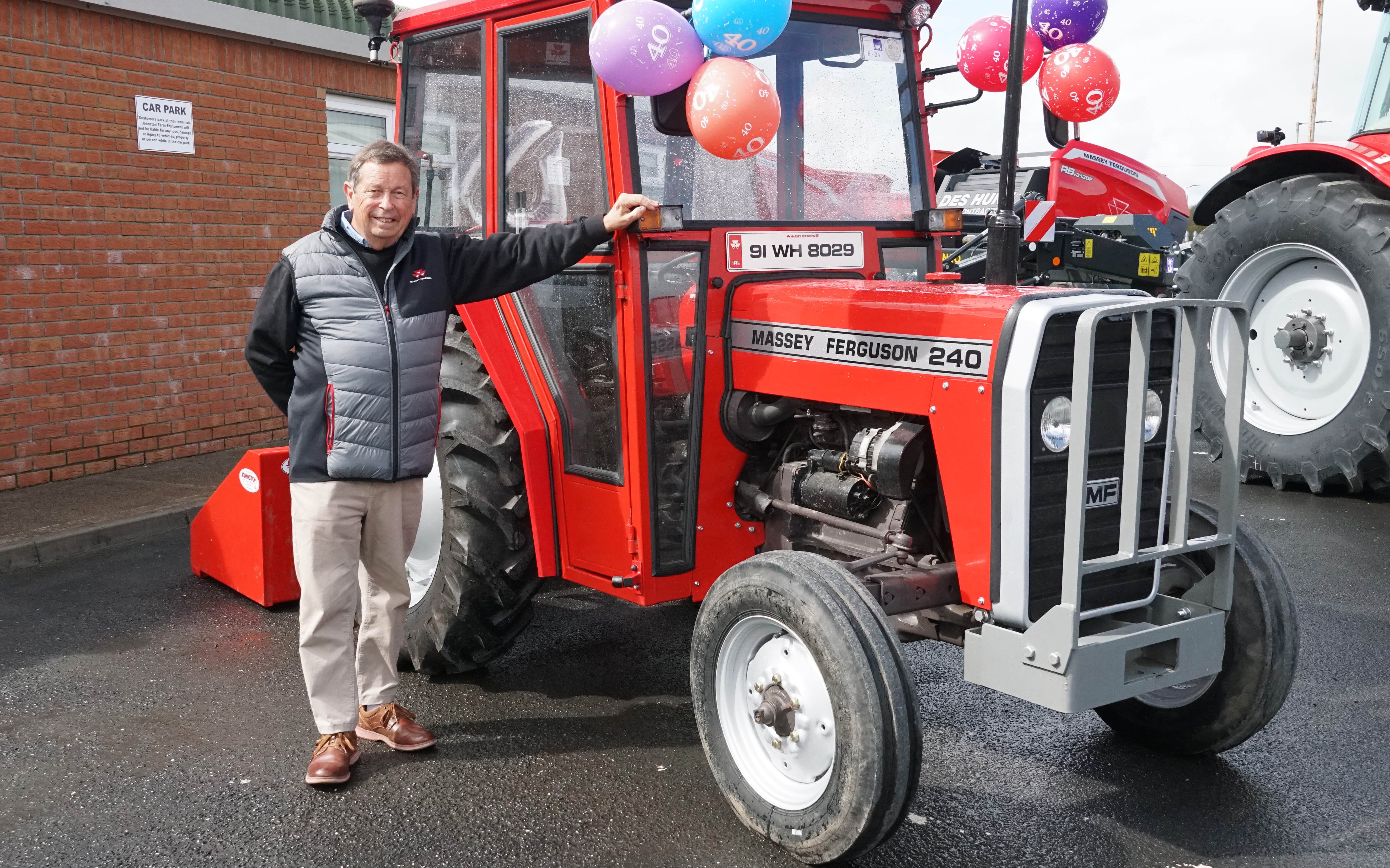 Derek Johnston standing next to a MF 240, a model that did well for him in the early days