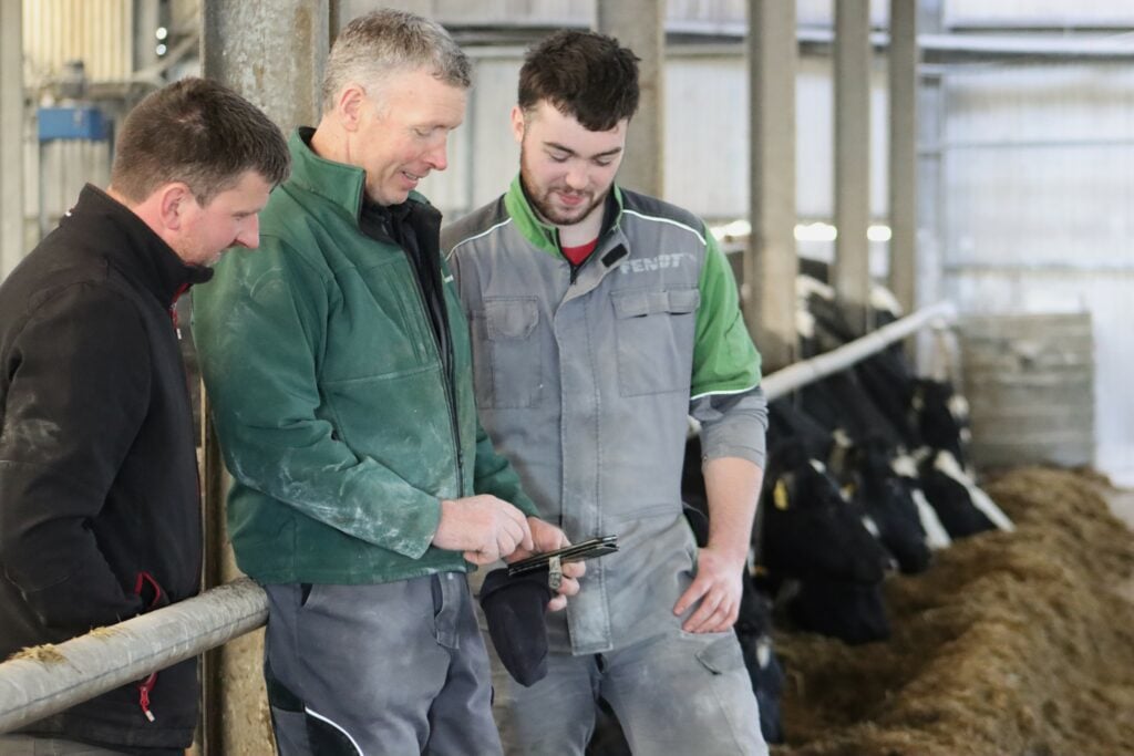 Dick and Eoin O'Neill showing their placement student, Nicholas, the benefits of CowControl