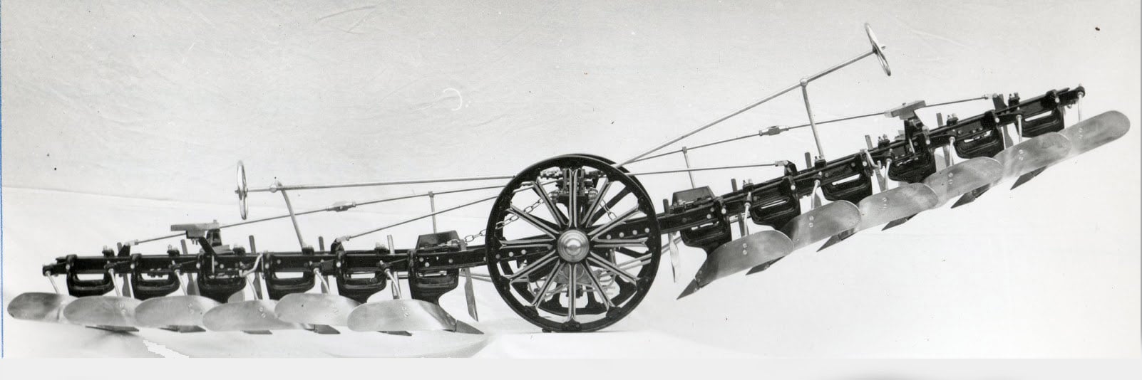 In essence this is a six furrow reversible plough, hauled between two engines, one at each side of the field