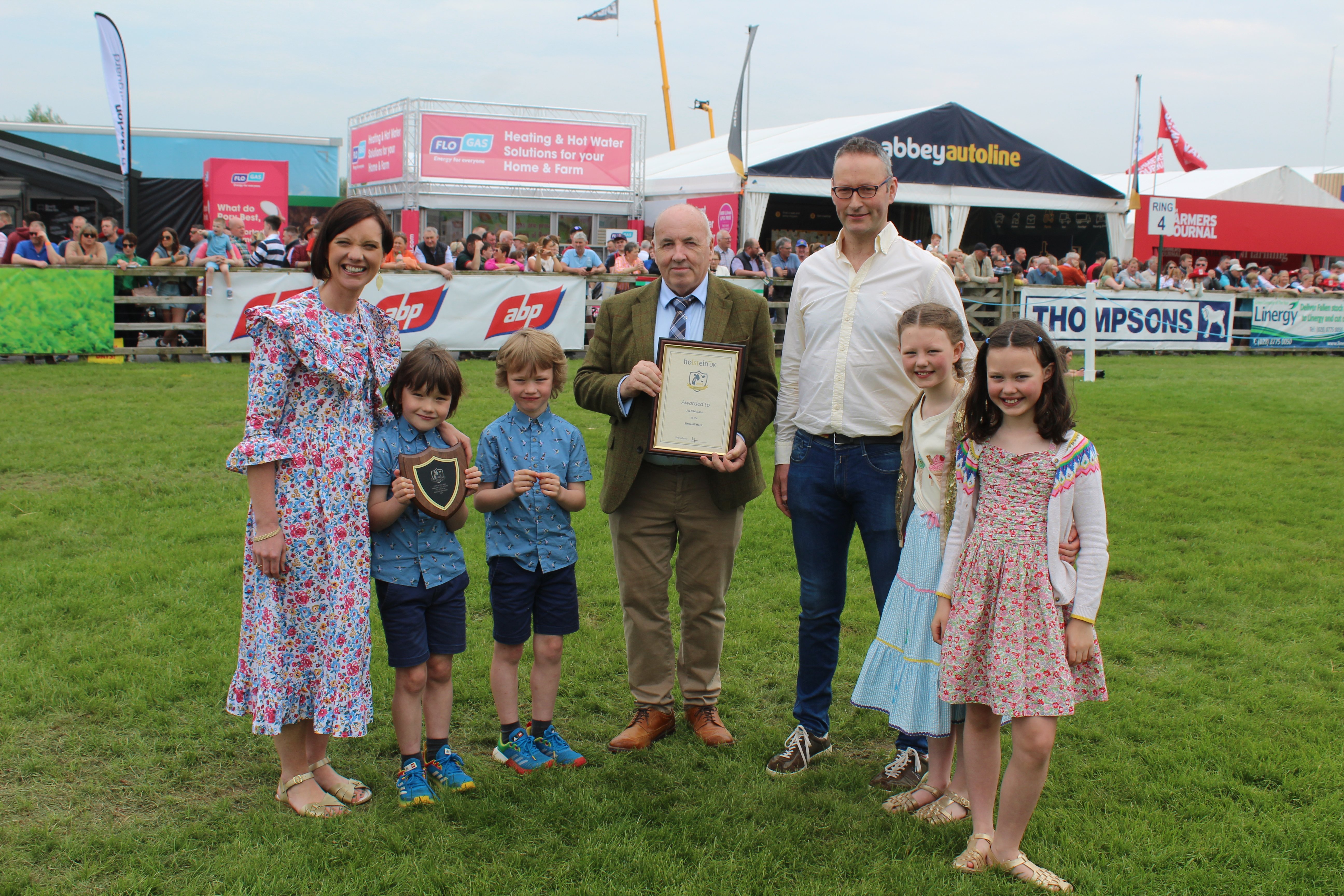 McCann family members, from Bangor in Co Down, receive their Holstein UK Master Breeder Award. L to r: Jill McCann with sons Ferris, and Finn; Holstein UK president Andrew Jones; and Nicholas McCann with daughters Acacia and Sienna