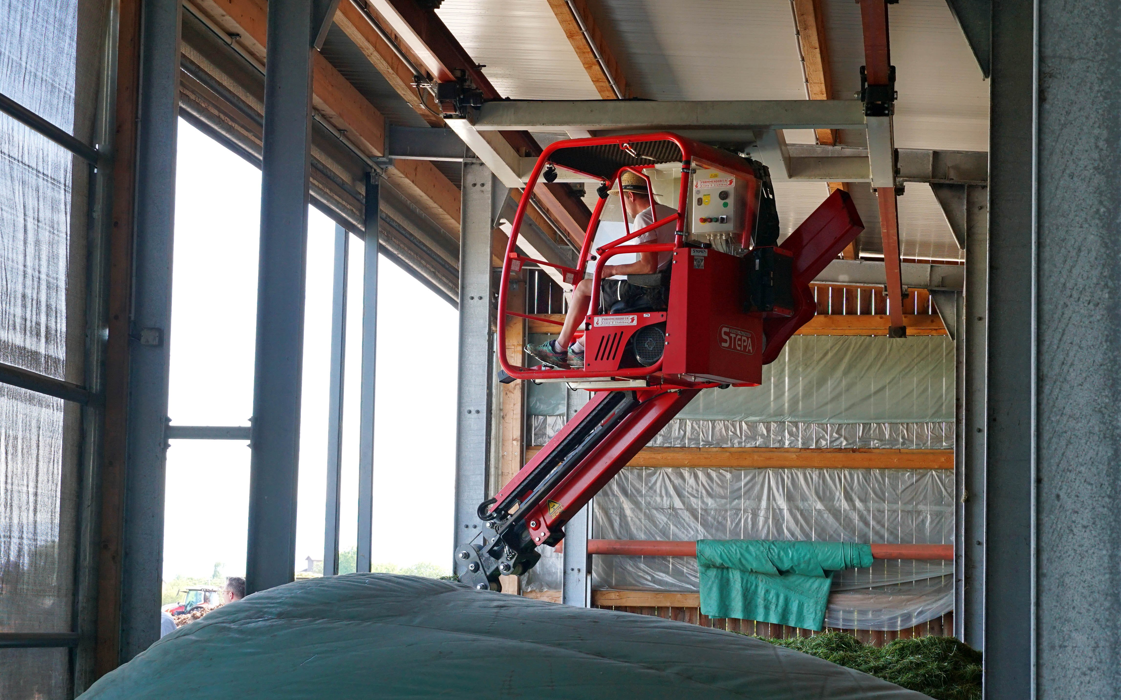 The gantry crane has an extendable boom and runs on a set of tracks attached to the frame of the building