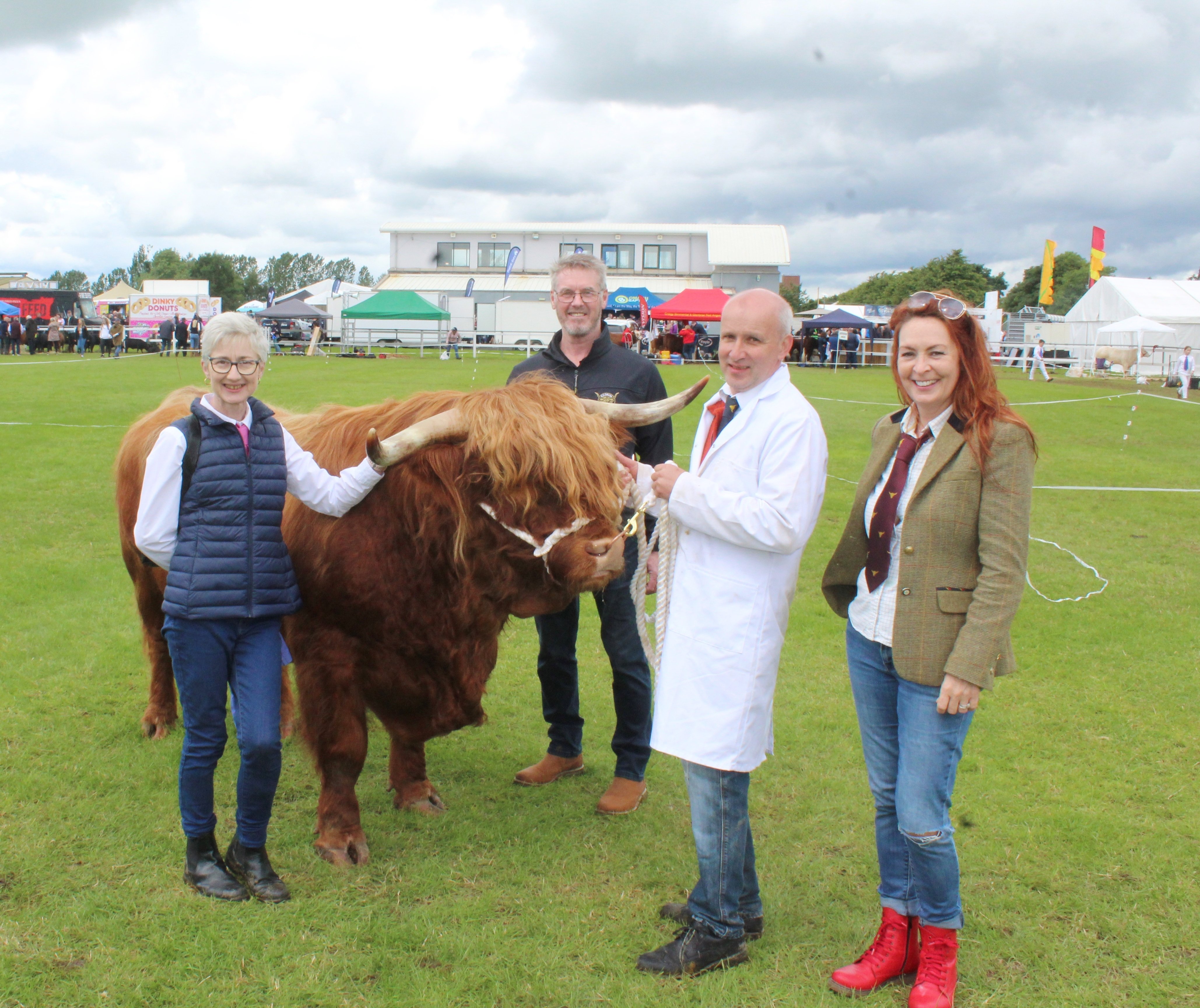 Eoin of Balmoral, the four-year-old Highland bull, competed at Omagh Show 2024. He was exhibited by (l-r): Linda Moore, Mayne, Omagh; Clive Backus, Ballymena; Alastair Moore; and Ashley Backus