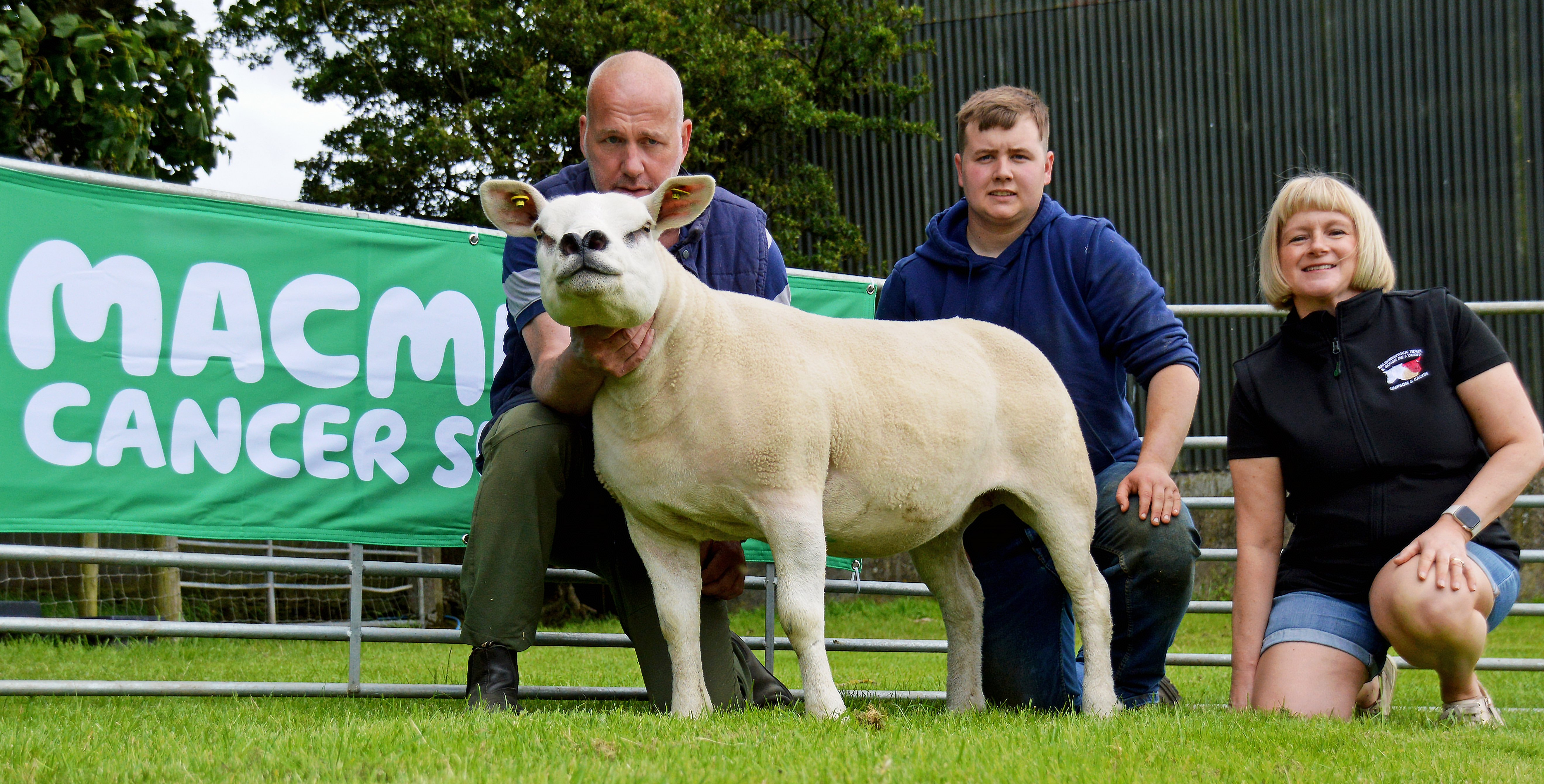 Roger Strawbridge, Owen Williams, and Christine Calvin with the Ballyhivistock Texel favourite for sale with proceeds to Macmillan Cancer Support