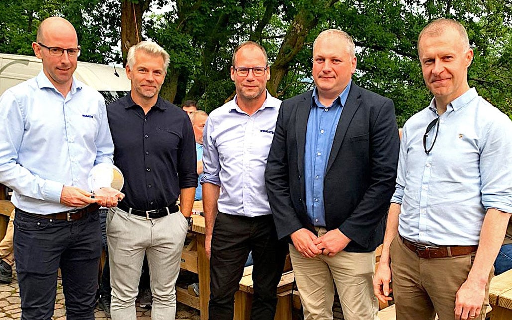 Dr. Jurgen Muntz, managing director, Komatsu Forest (3rd from right) with McHale's sales director, Denis McGrath (4th from right)