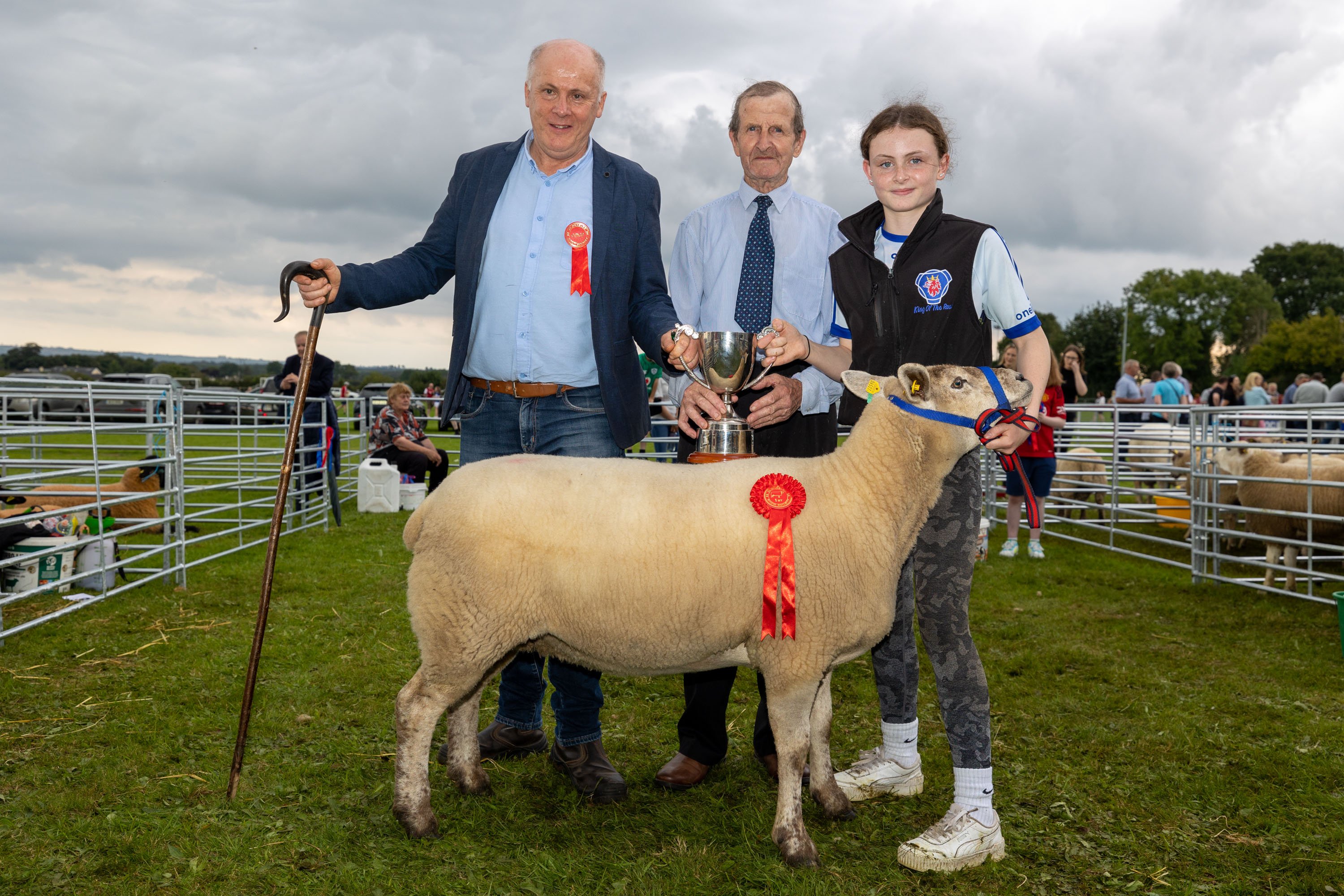 Laura McCabe from The Leap, Roscrea with her overall champion commercial ewe, judge Pat Oliver and her grandfather Pat McCabe at Clonaslee Show 2023. Image source: Alf Harvey
