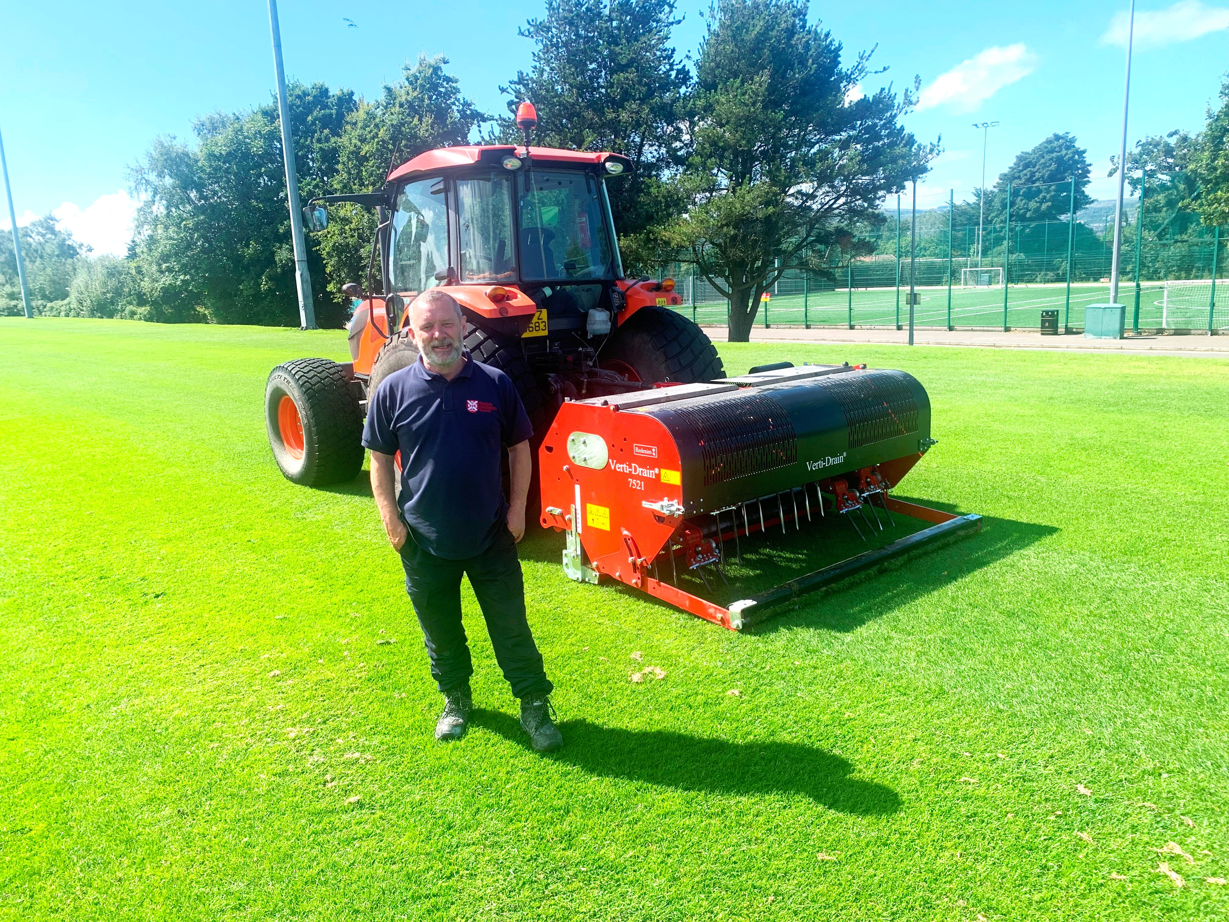 Member of QUB’s grounds care team, John Tumilson, standing in front of the new aeration system