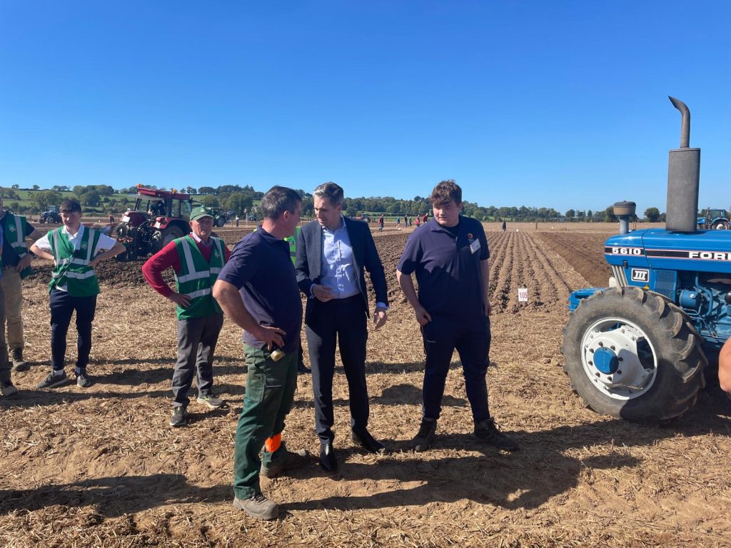 Jer Coakley, Taoiseach Simon Harris, and Eugene O'Donovan at the ploughing site today