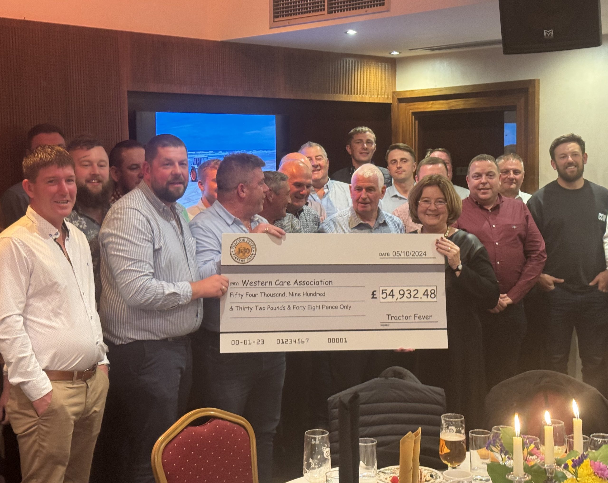 Tractor Fever Vintage Club present a cheque from their London to Donegal Tractor Run to Mary Boyd, chief executive officer of Western Care Association