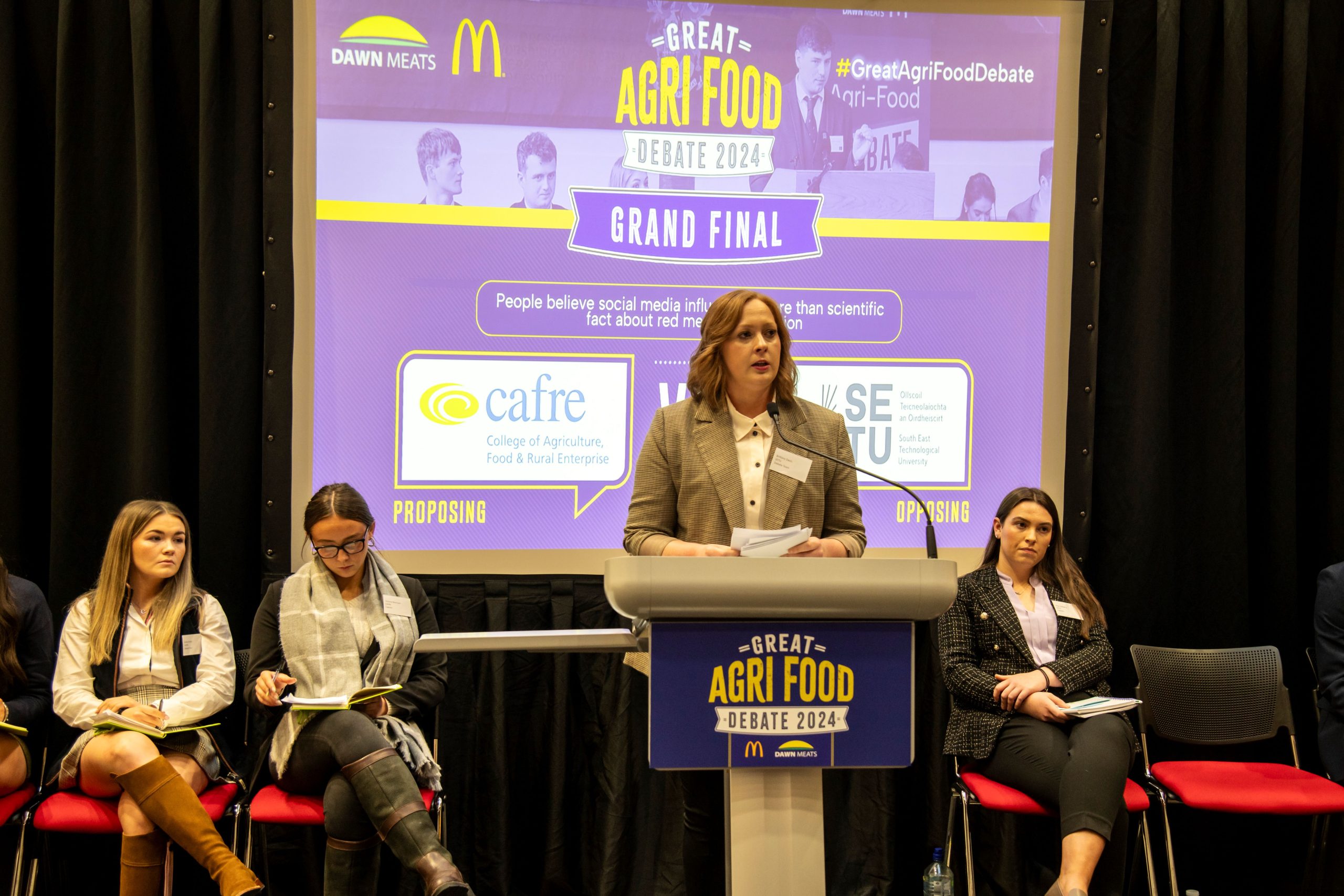 SETU team member Brittany Davis delivering her debate arguments. Also pictured CAFRE’s Emma Forbes, who was awarded Best Speaker, alongside team captains Victoria Morrison, CAFRE, and Ellen Doherty, SETU. Image: Kevin McFeely.