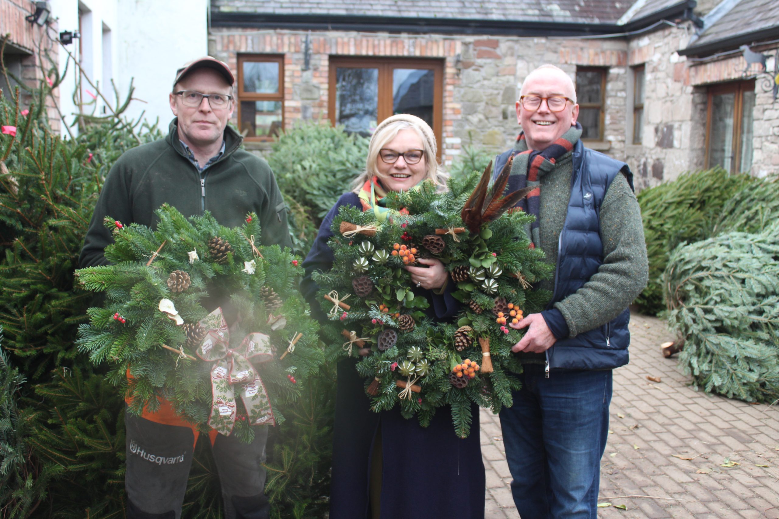 Sorting out a wreath for Christmas: Tony Johnston with Susan and Alan Logan from the Stormont area of Belfast