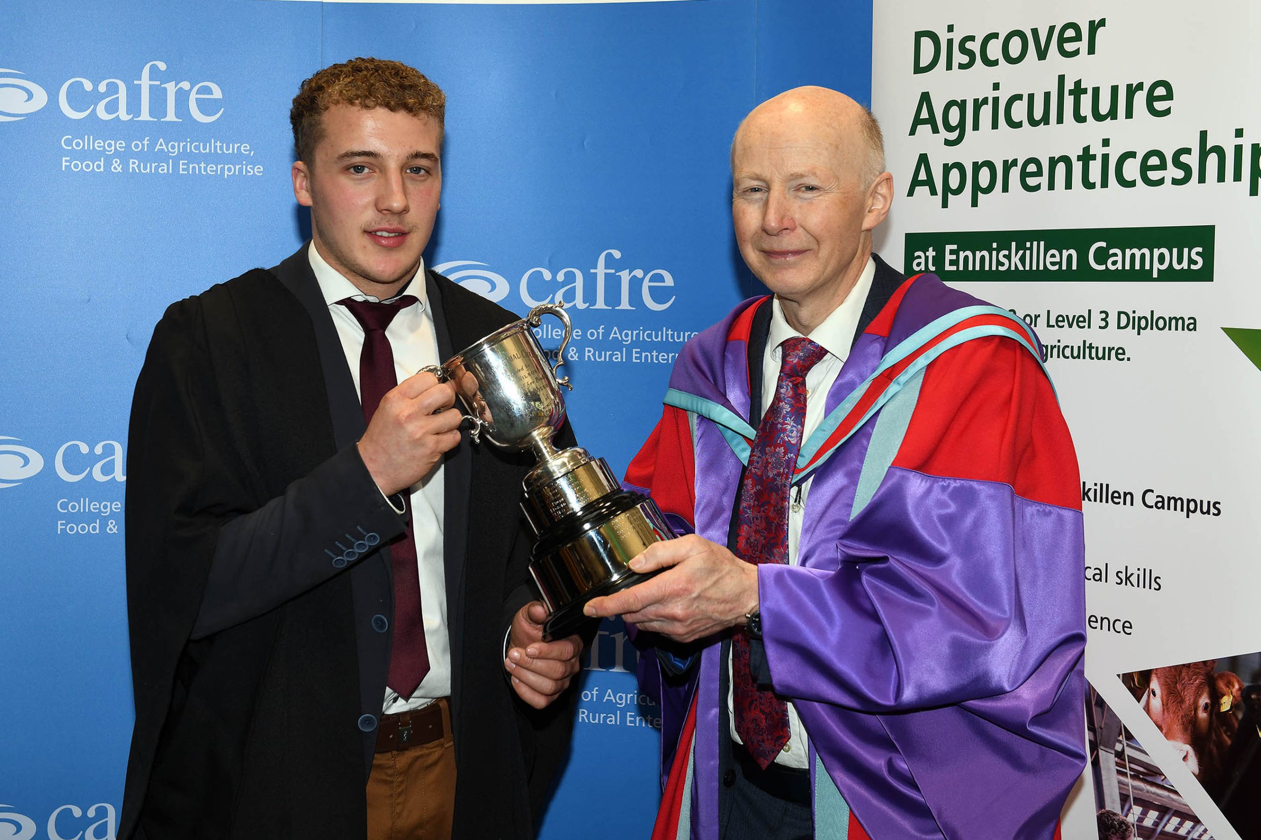 Michael Bothwell from Fivemiletown being presented with the William Wilson Cup by Dr. Eric Long, head of education, CAFRE
