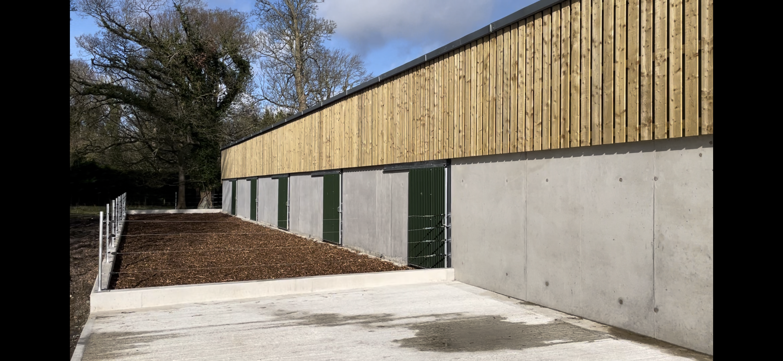 Outdoor wood-chip area for calves to rear of shed