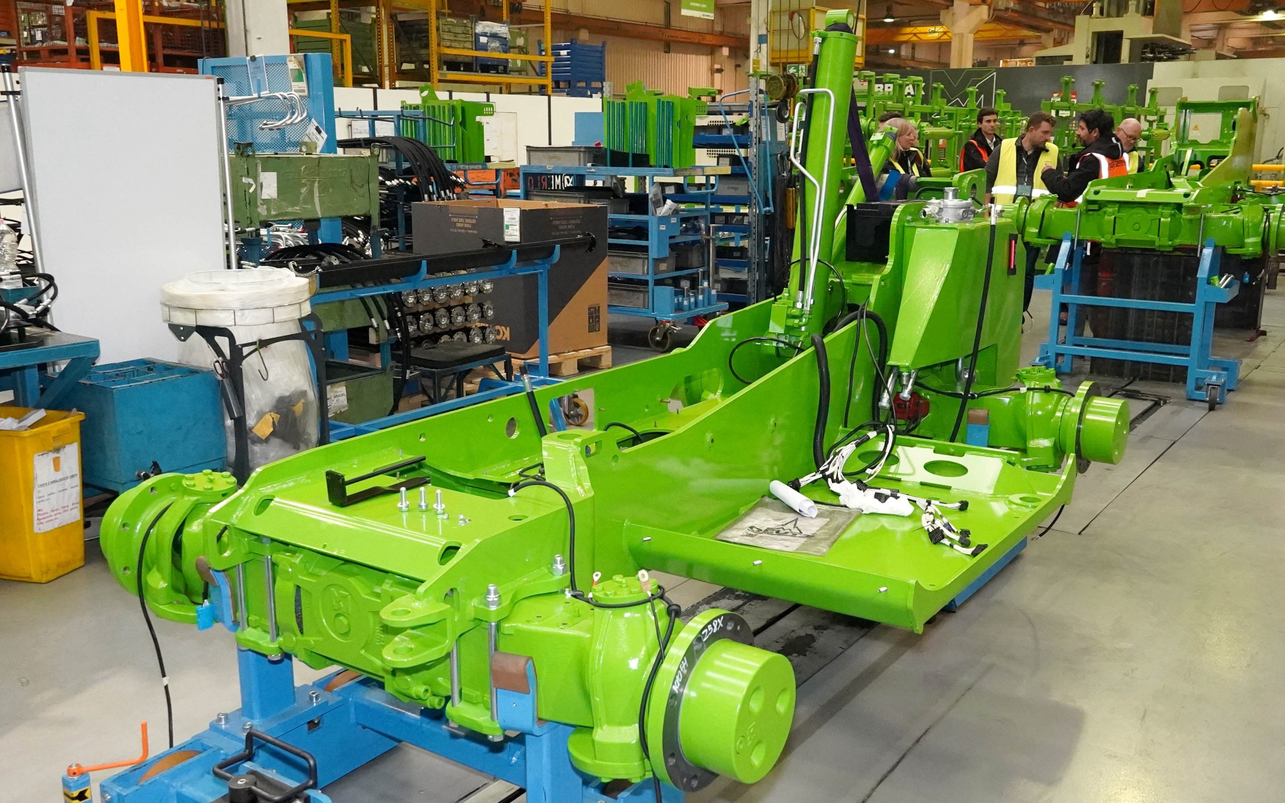 Axles are mounted to the frame before the cab and boom are installed