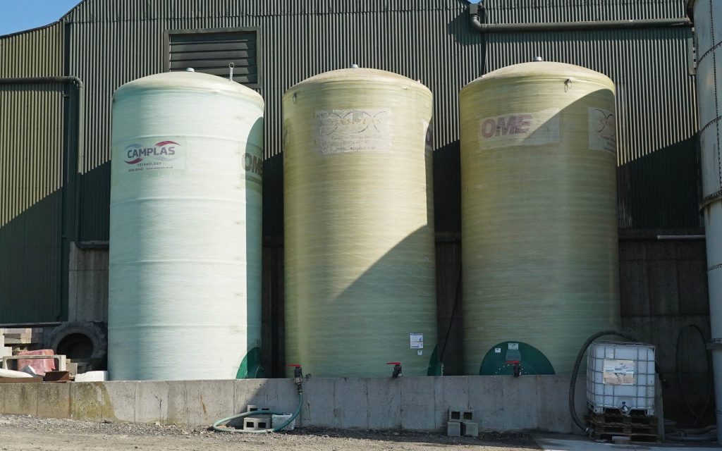 Storage tanks are best sited close to a building to reduce the risk of wind damage