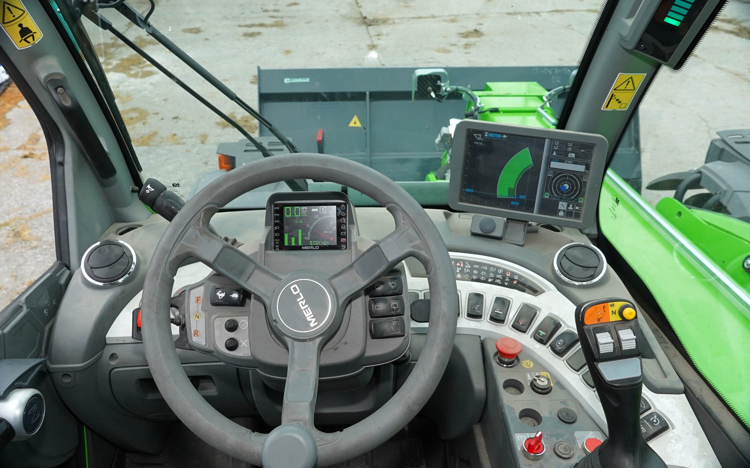 The cab interior and control layout draw praise, with the joystick being highlighted as workable and precise