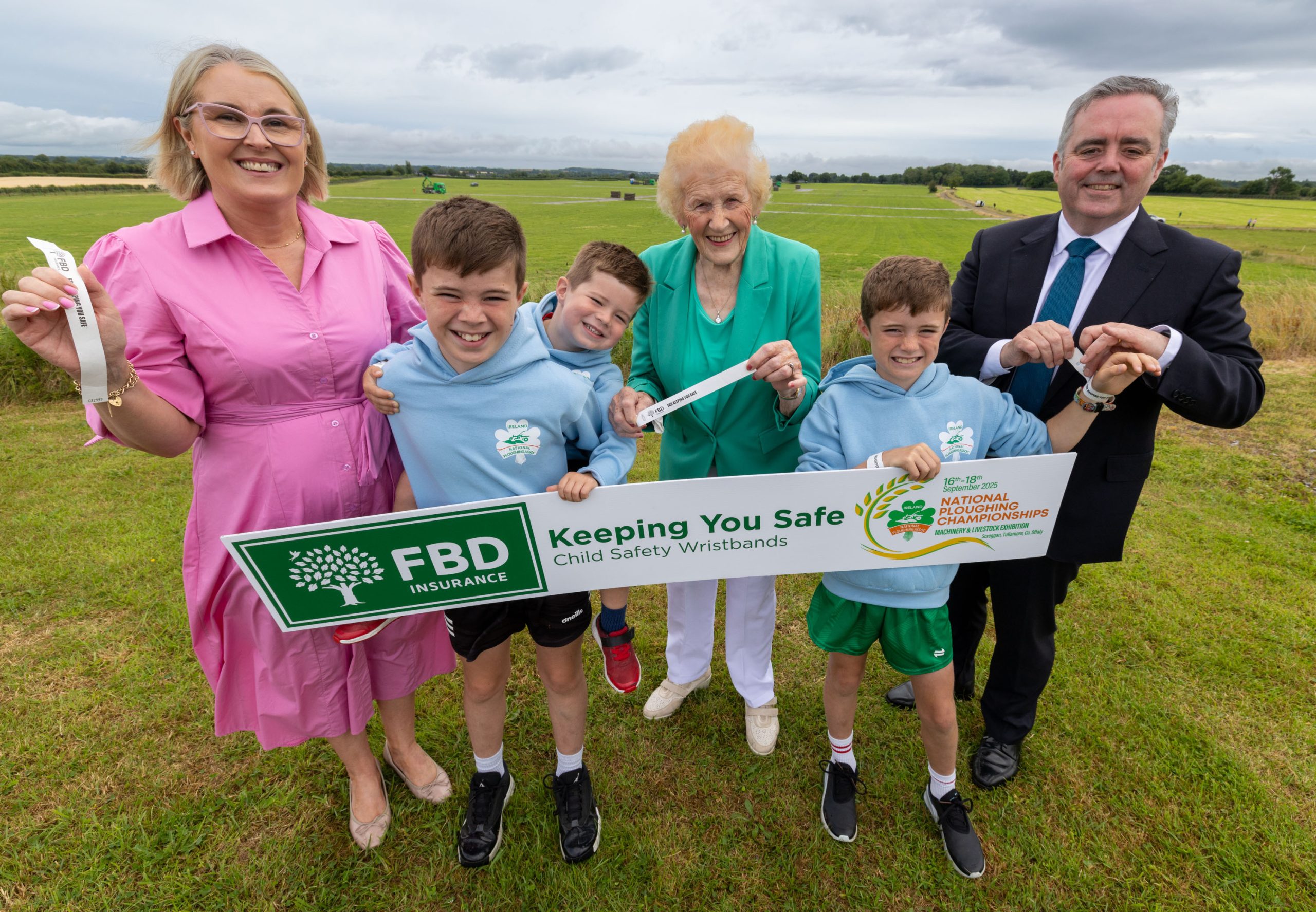 NPA’s Anna May McHugh, Maureen O’Meara, and FBD’s Tomás O’Midheach with Fergus, Liam and Sean Conroy launching the children’s wristbands on the site of the 2025 National Ploughing Championships. (Source: NPA)