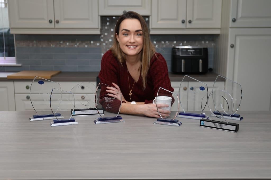 Áine with some of the awards the business has won