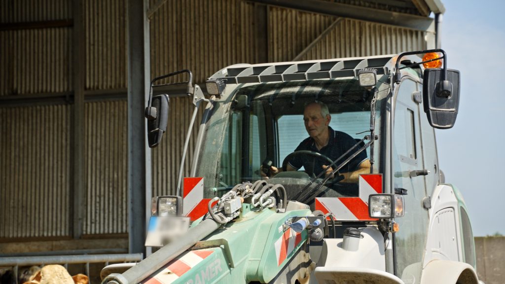 Padraig driving a loader on his yard