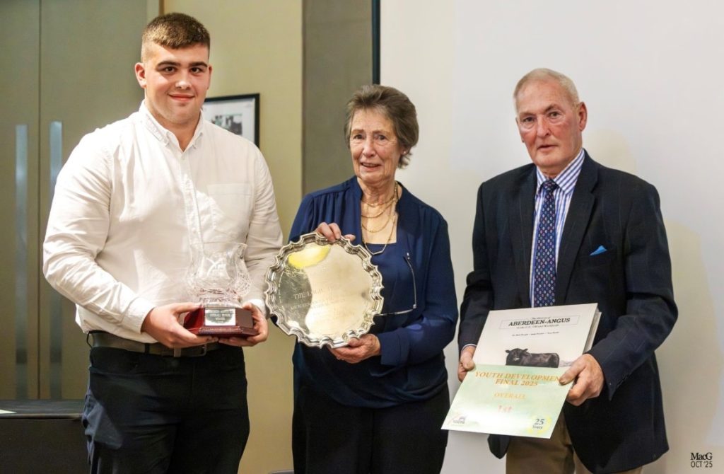 The Overall Senior Champion James Morrison presented with his award by John and Marion Tilson of the Wedderlie Herd