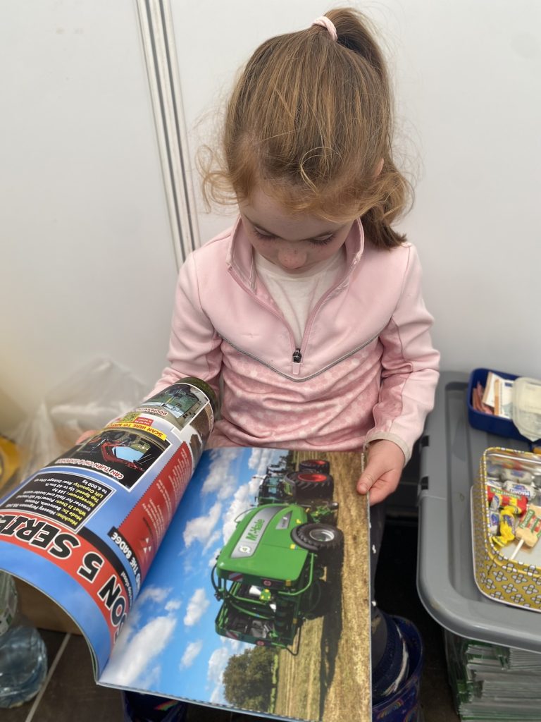6-year-old Adia Grennan from Rhode in Co. Offaly took time out at the Ploughing to read her AG MAG.