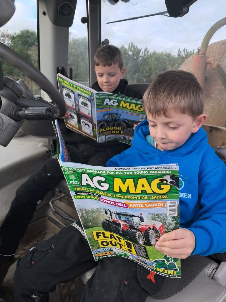 AG MAG fans Patrick and Cillian Hearne from Leperstown in Co. Waterford take time out in the cab to sneak a read of their magazines.