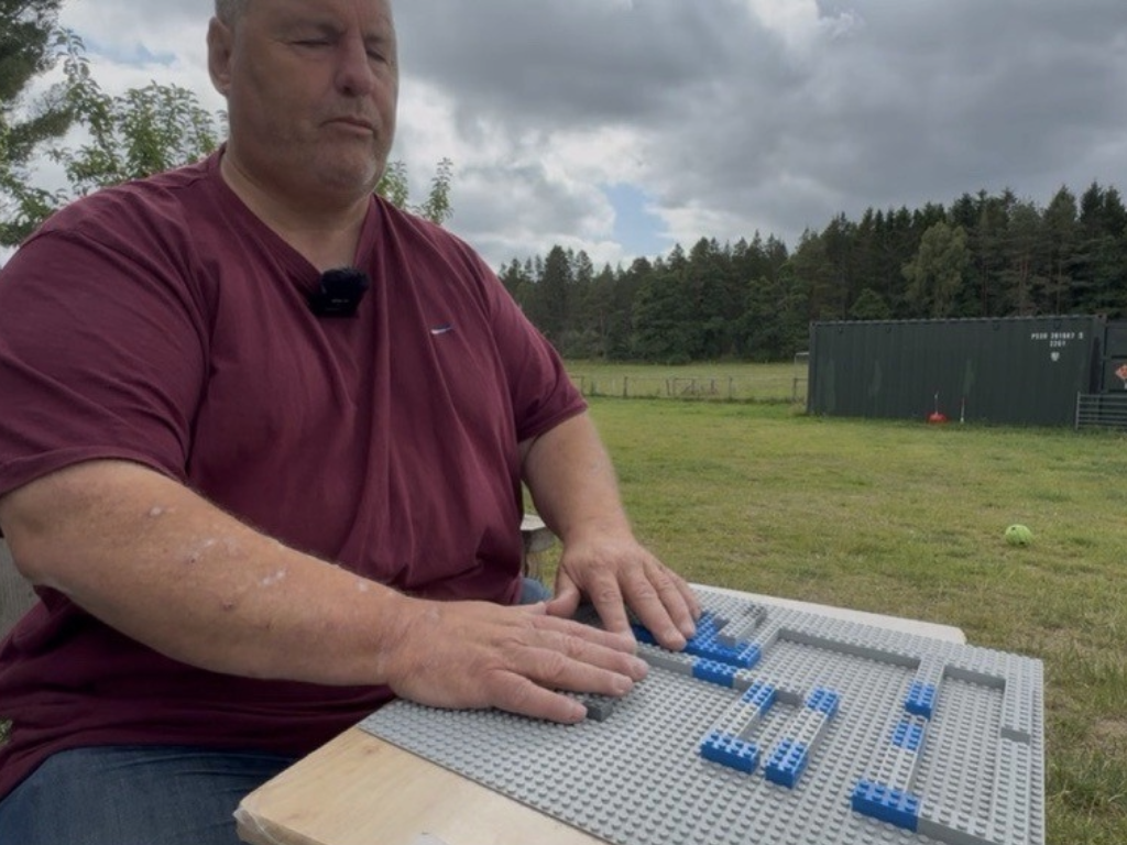 Mike Duxburry demonstrating how he uses Lego to design facilities for the farm