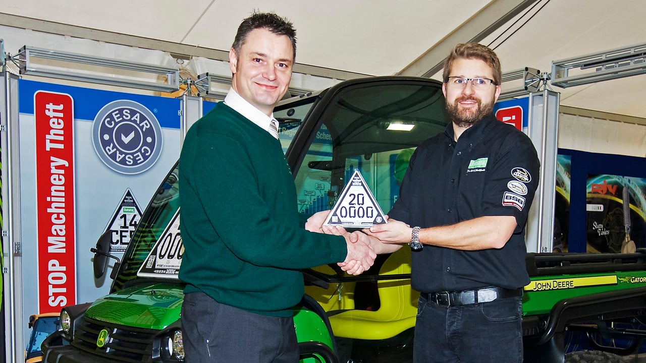 John Deere Limited marketing manager Chris Wiltshire (left) and Datatag sales manager Chris Harrison with the 200,000th CESAR marked machine, a John Deere XUV 855D Gator utility vehicle, on the CESAR Scheme stand at LAMMA 2015.