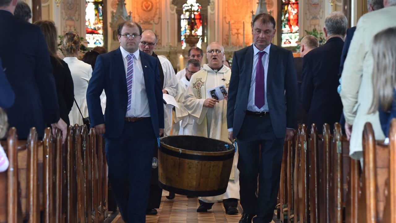 Macra President, James Healy, and ICMSA President, John Comer, bringing earth out of the church to plant a hawthorn tree on the grounds. Image source: Roger Jones