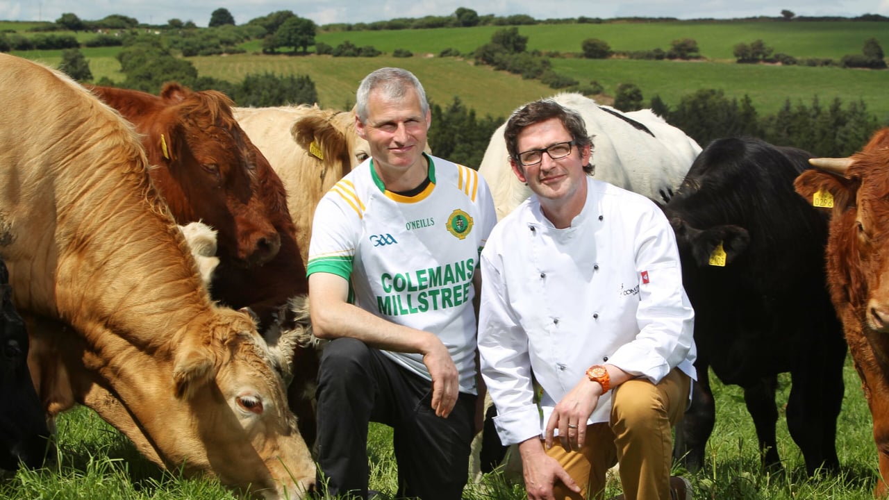 Beef Farmer Michael Barrett wearing the GAA jersey of his local club Millstreet pictured on his farm in Kilcorney, Co. Cork pictured alongside Iain Flynn, Head Chef, Compass Group Ireland. Image source: Diane Cusack