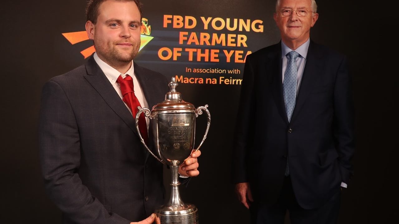 Owen Ashton, FBD Young Farmer of the Year, receiving the trophy from Michael Berkery, chairman, FBD Trust
