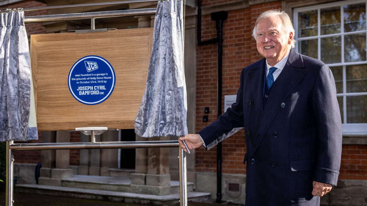 Lord Bamford unveiling a Blue Plaque at the site of his father's original workshop