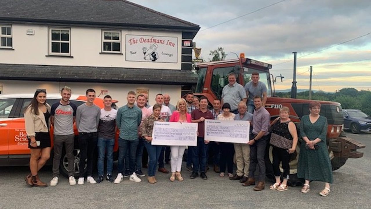 Angela (centre) receives cheque raised for Teac Tom by the Rev for Trev tractor run