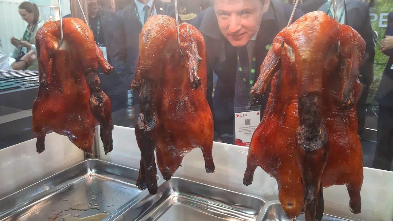Minister for Agriculture, Food and the Marine, Charlie McConalogue examines roast Silver Hill Duck at the Bord Bia Ireland stand at the Food and Hotel Asia trade show in Singapore
