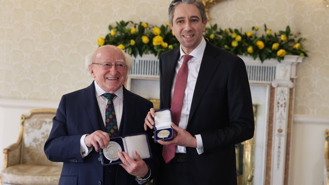President Michael D Higgins presenting Taoiseach Simon Harris with his warrant of appointment and seal of office Source: @merrionstreet
