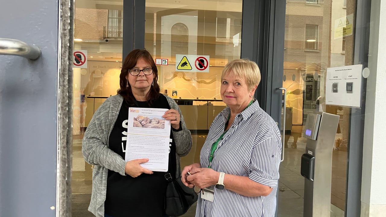 Founder and director of EFI, Caroline Rowley handing over a signed petition to a DAFM representative