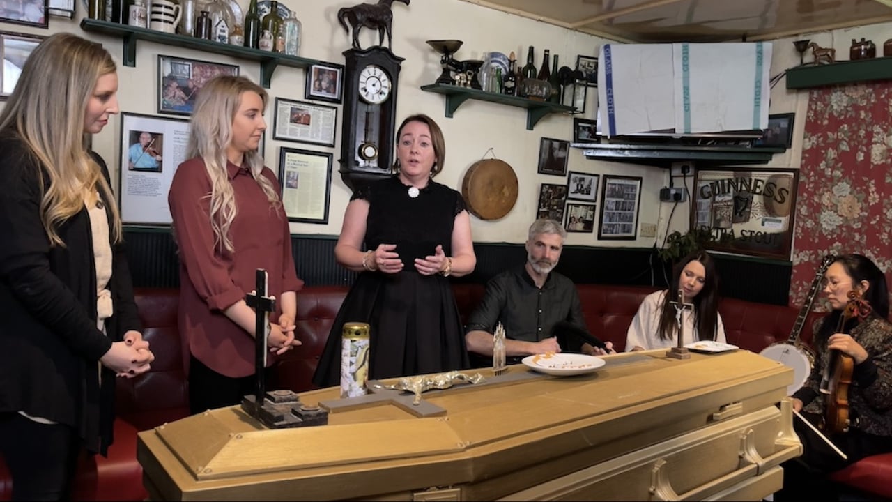 Wonders of the Wake sean nós singer Caitríona Ni Chennabháin (third from left) singing over the coffin at an Irish wake. Source: MRF 2025