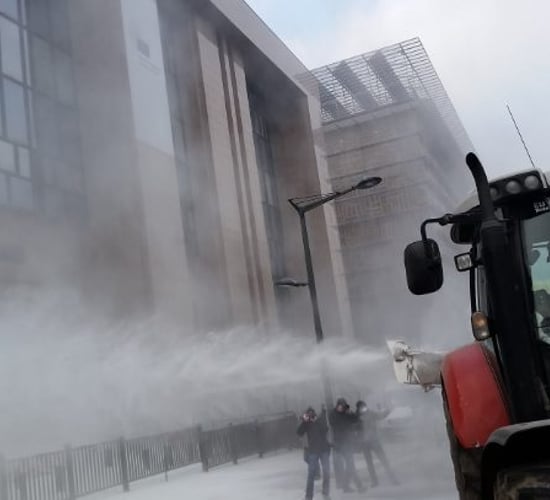 Pics: Farmers coat EU Council buildings with milk powder in protest