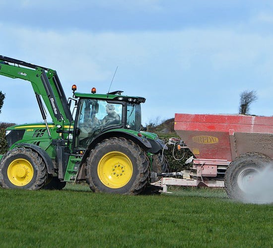 What are the benefits of correcting soil pH through lime?